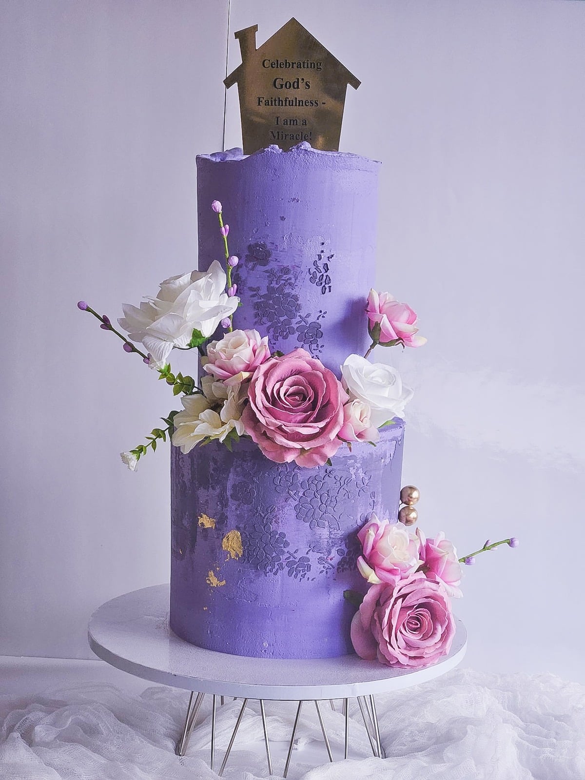 Two-tier lavender cake with sugar roses